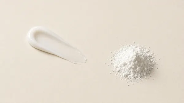 A smear of white cream next to a mound of fine white powder