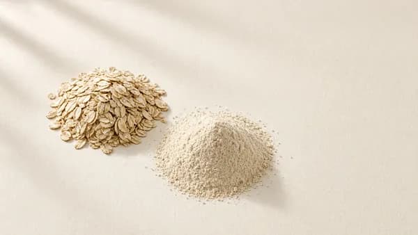 Rolled oats beside a mound of finely milled oat powder